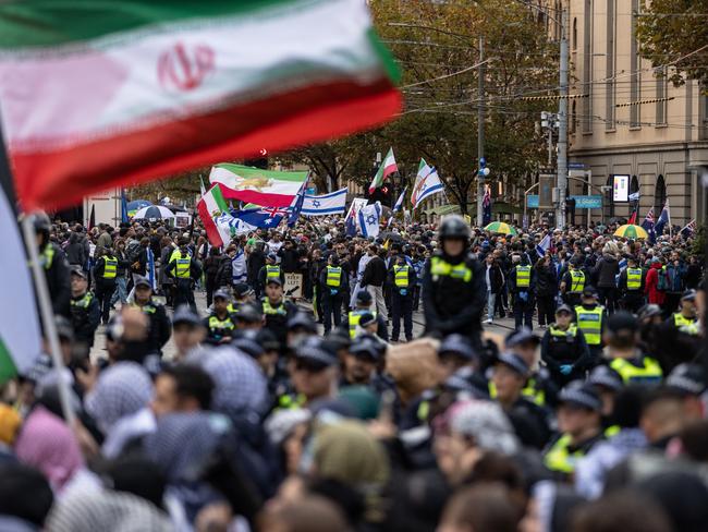 MELBOURNE, AUSTRALIA - MAY 19: Pro-Palestine activists gather near the Victorian Parliament as members of Victoria Police stand guard to avoid clashes with the other grou on May 19, 2024, in Melbourne, Australia. A counter-rally organised by Pro-Palestine activists is taking place near the steps of Parliament as a "Never Again is Now" pro-Israel rally occurs in the same place. (Photo by Diego Fedele/Getty Images)