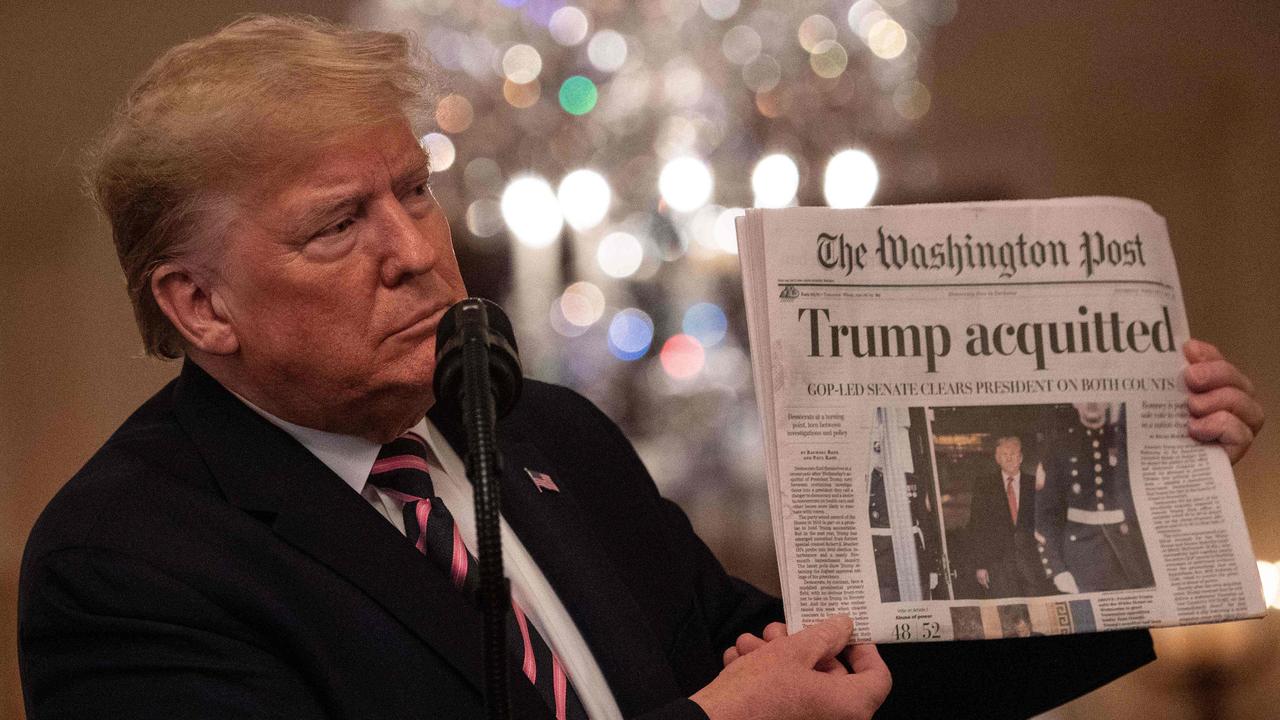 Donald Trump brought along a copy of the Washington Post, trumpeting its headline: “Trump acquitted.” Picture: Nicholas Kamm/AFP