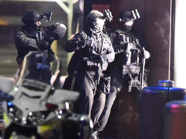 Heavily armed police outside the Lindt shop in Martin Place. Picture: Gordon McComiskie