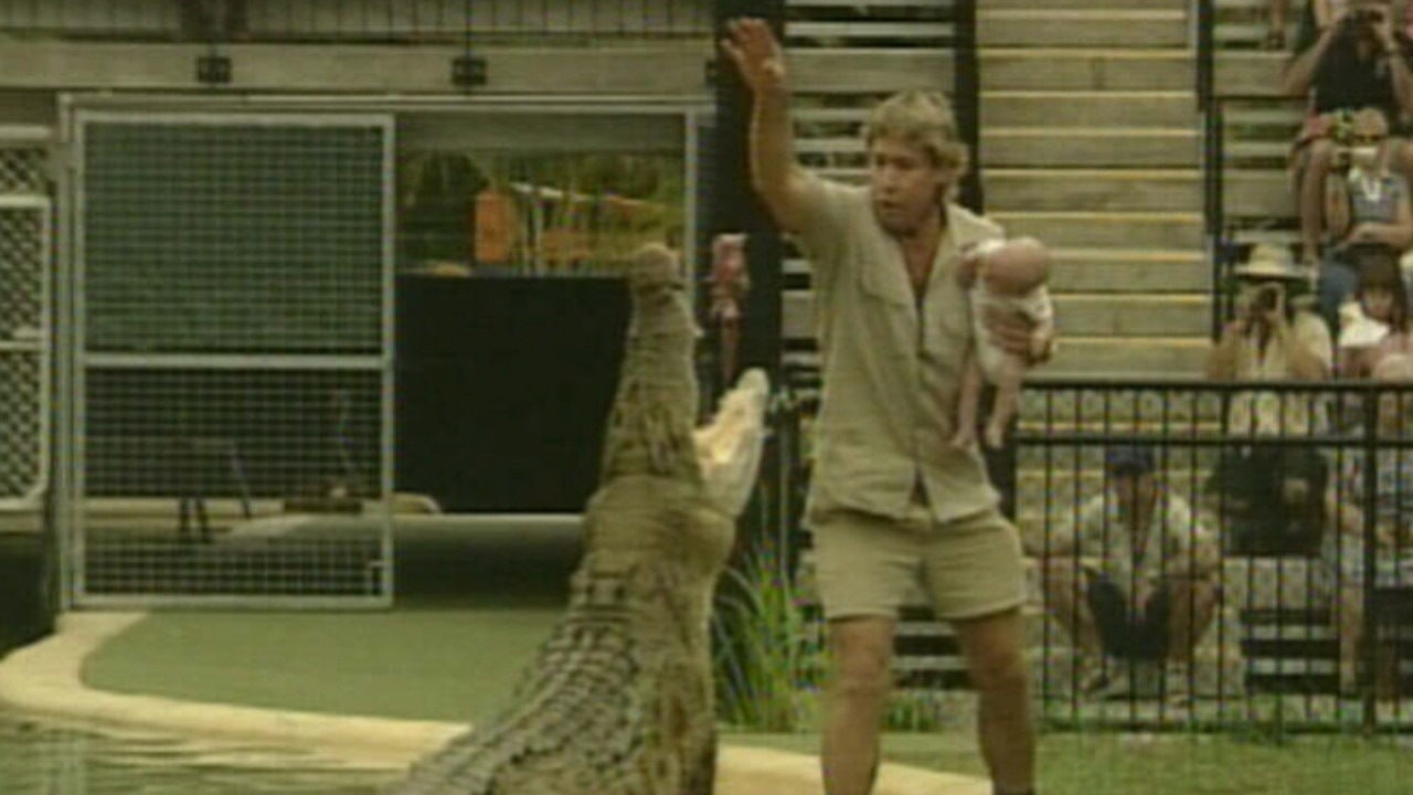 Steve Irwin holds Robert while feeding a crocodile in 2004. Picture: Supplied / Channel 7 / Irwin family