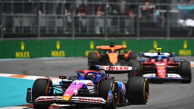 Daniel Ricciardo holding off a Ferrari. Photo by Rudy Carezzevoli/Getty Images.