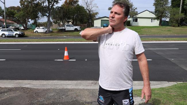 Witness John Elias shows us how the police held the throat of the accused to stop the bleeding. Picture: John Feder/The Australian.