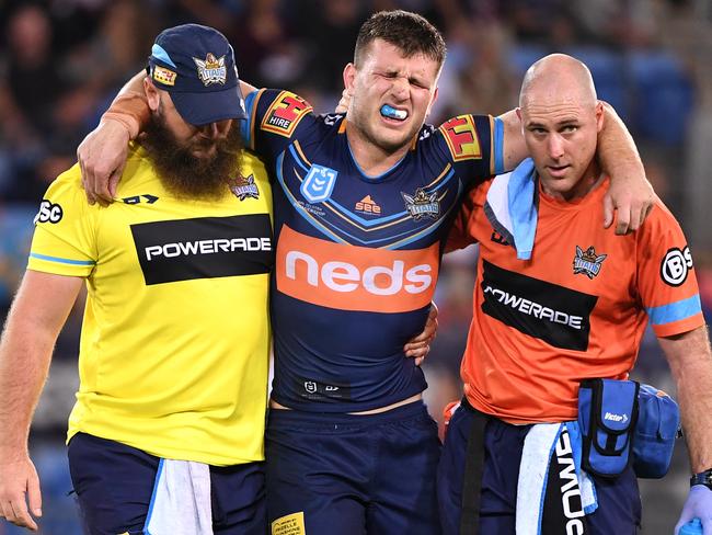 Jai Arrow of the Titans is taken from the field injured during the Round 14 NRL match between the Gold Coast Titans and the New Zealand Warriors at CBus Super Stadium on the Gold Coast, Friday, June 14, 2019.  (AAP Image/Dave Hunt) NO ARCHIVING, EDITORIAL USE ONLY