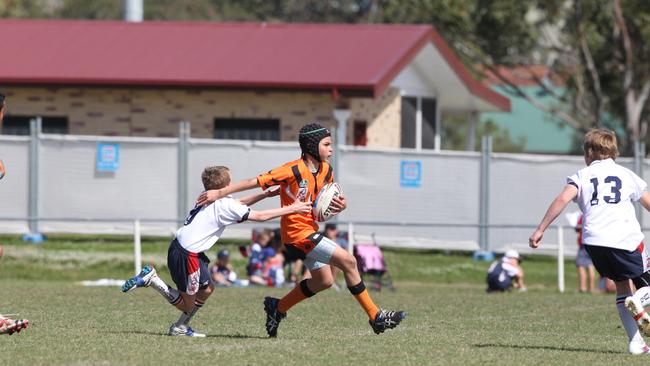 Max Dowd with ball in under-12s at Southport Tigers league club.