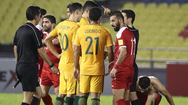 MALACCA, MALAYSIA — OCTOBER 05: Australian players talk to referee Alireza Faghani after the 2018 FIFA World Cup Asian Playoff match between Syria and the Australia Socceroos at Hang Jebat Stadium on October 5, 2017 in Malacca, Malaysia. (Photo by Robert Cianflone/Getty Images)