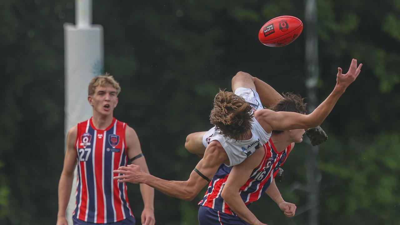 Up and over - Tom Waters is climbed all over against the Roos. Photos by Stephen Archer