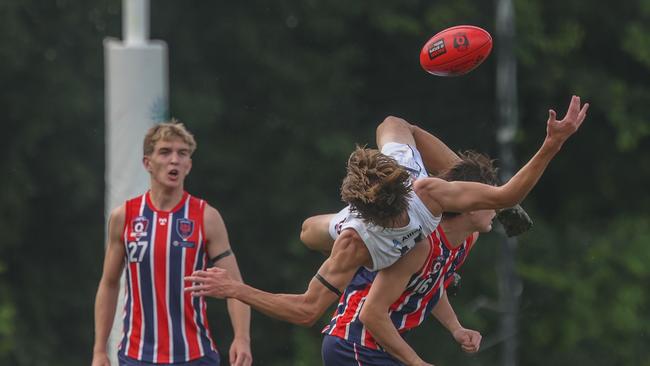Up and over - Tom Waters is climbed all over against the Roos. Photos by Stephen Archer