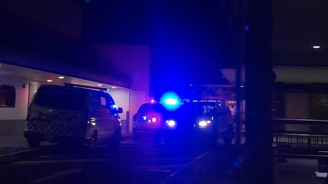 Police outside the Runaway Bay shopping centre on Friday night.