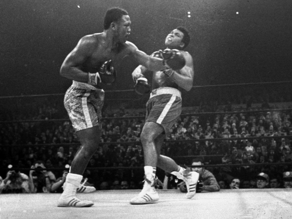 March 8, 1971: Joe Frazier (left) hits Muhammad Ali during the 15th round of their heavyweight title fight at New York's Madison Square Garden. Frazier died of cancer in 2011.