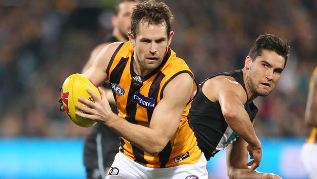 Luke Hodge gets past Chad Wingard at Adelaide Oval.