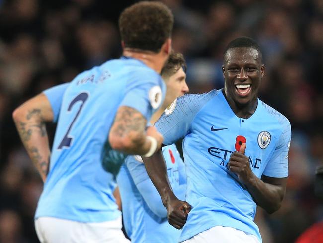 Manchester City's English defender Kyle Walker (L) and Manchester City's French defender Benjamin Mendy celebrate after winning the English Premier League football match between Manchester City and Manchester United at the Etihad Stadium in Manchester, north west England, on November 11, 2018. (Photo by Lindsey PARNABY / AFP) / RESTRICTED TO EDITORIAL USE. No use with unauthorized audio, video, data, fixture lists, club/league logos or 'live' services. Online in-match use limited to 120 images. An additional 40 images may be used in extra time. No video emulation. Social media in-match use limited to 120 images. An additional 40 images may be used in extra time. No use in betting publications, games or single club/league/player publications. /
