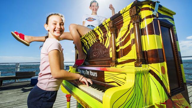 Sandgate sisters Florence and Audrey Power had fun playing a piano at Shorncliffe Pier as part of the Play Me, I'm Yours project. Picture: Lachie Millard