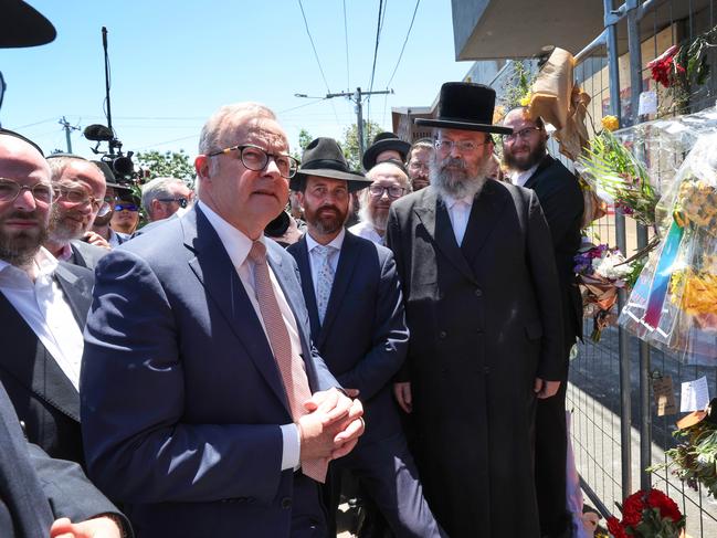 Prime Minister Anthony Albanese visits the fire damaged Adass Israel Synagogue in Ripponlea. The PM is greated by Jewish community leaders and walks to the temporary fence covered in flowers.                                                             Picture: David Caird