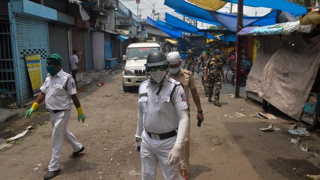 Police personnel patrol to clear a market area during a lockdown imposed as a preventive measure against the spread of the COVID-19 coronavirus in Siliguri, India. Picture: AFP