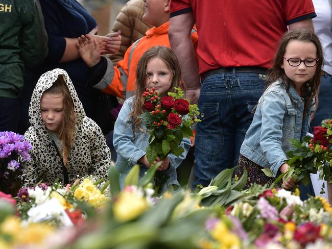 Children leave flowers at the gates following the proclamation of King Charles III at Hillsborough Castle. Picture: Getty