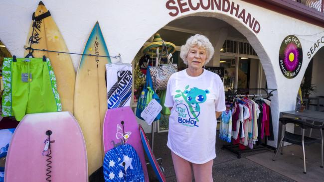 Bribie Island local Bev Powell working in her Op-Shop says she doesn’t know what to believe. Photo: Glenn Hunt