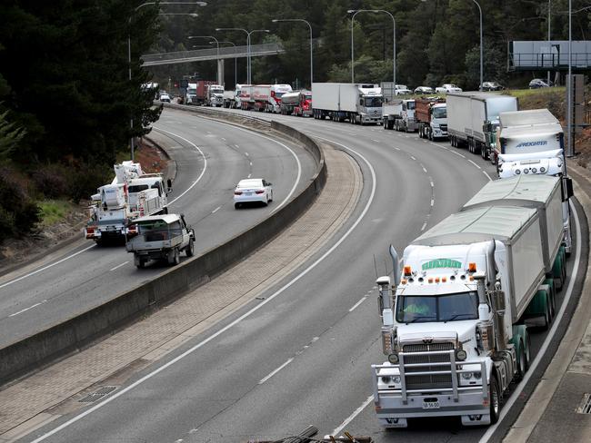 Trucks are banked up as they wait for the overturned truck to be removed. Picture: AAP / Kelly Barnes