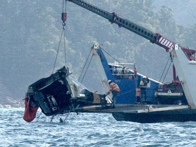 #NO AUSTRALIAN, NO NEWSWIRE NO ONSALE # A barge anchored at the site where a MRH 90 military helicopter crashed, lifts out the tail section. in the Whitsundays while carrying four Australians -Saturday 29 July 2023 Picture:Michaela Harlow