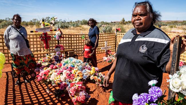 Police shooting victim Kumanjayi Walker’s foster mother Leanne Oldfield visits his grave in Yuendumu with three of Walker’s relatives. Picture: Amos Aikman