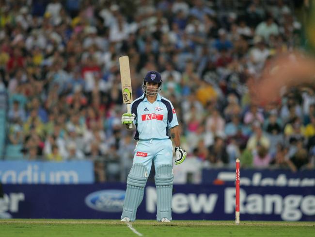 Andrew Johns raises his bat after scoring his first first-class run.