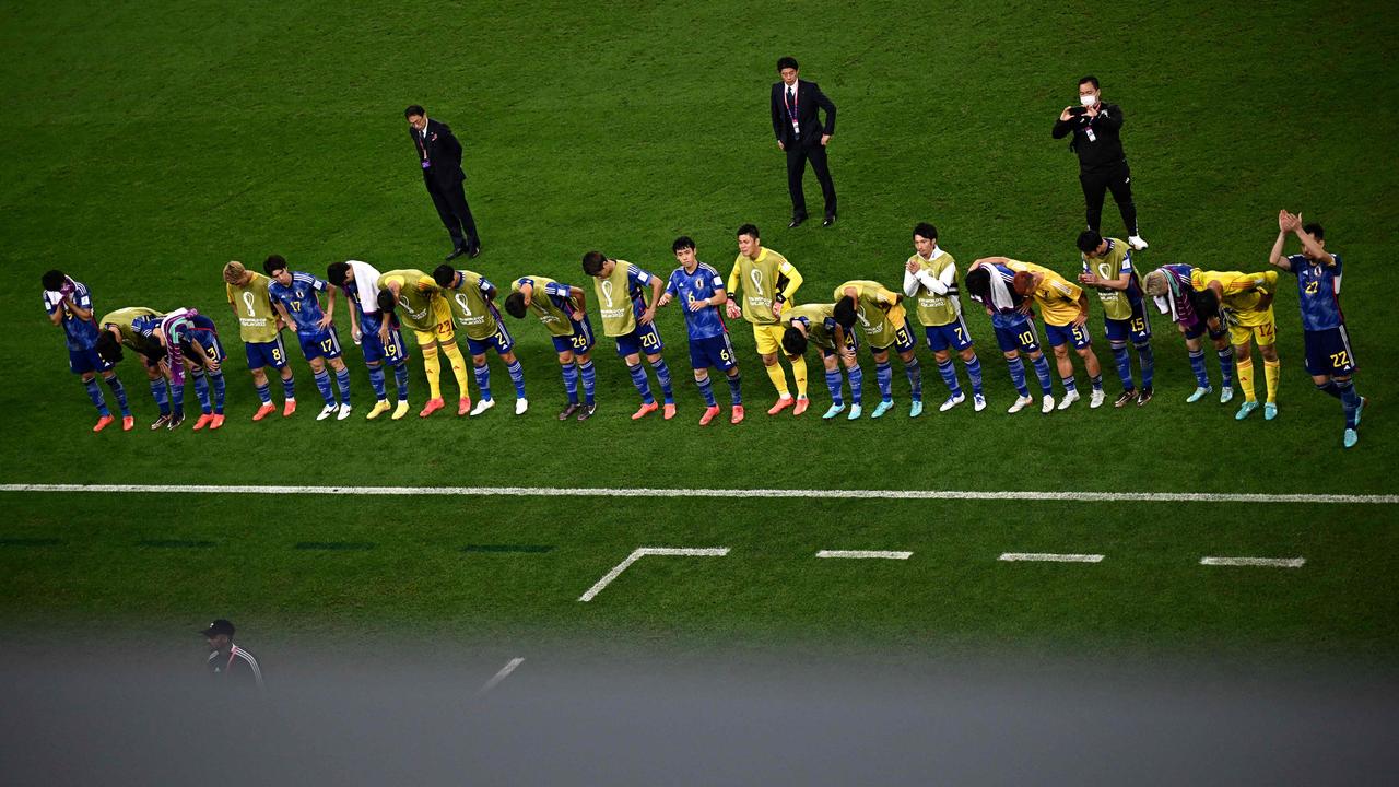 Japan's players bow to fans after losing. Photo by Anne-Christine POUJOULAT / AFP.