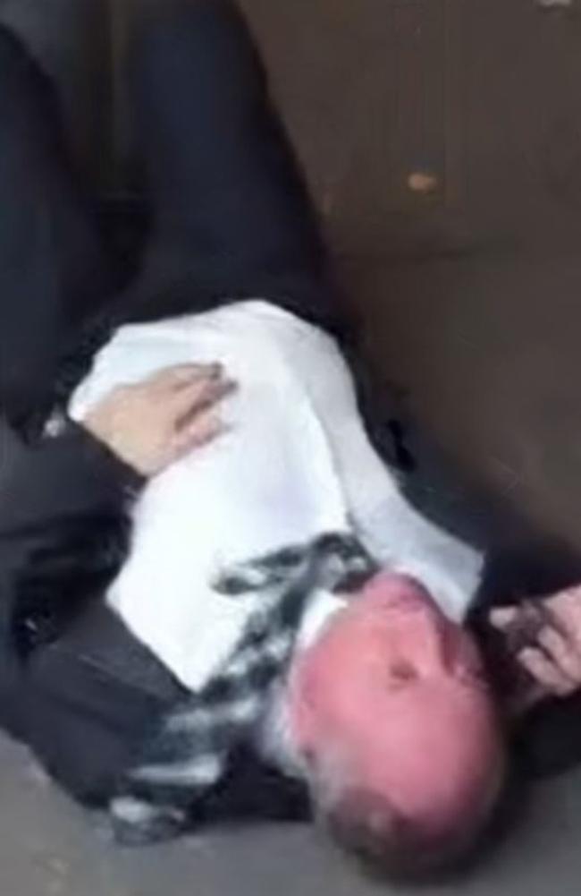 Nationals MP Barnaby Joyce caught on video lying on a Braddon street while swearing on the phone. Picture: Twitter