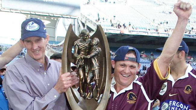 Wayne Bennett and Walters lift the trophy after the 2000 decider.