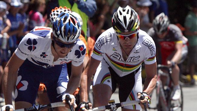 Cadel Evans, right, in the rainbow jersey as he makes an attack up Willunga Hill during the 2010 event. Picture: Sarah Reed