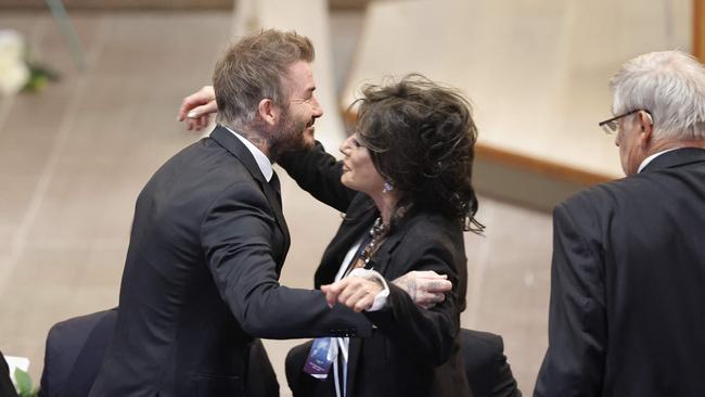 David Beckham and Nancy Dell'Olio hug, Photo by Adam Ihse/TT / TT News Agency / AFP