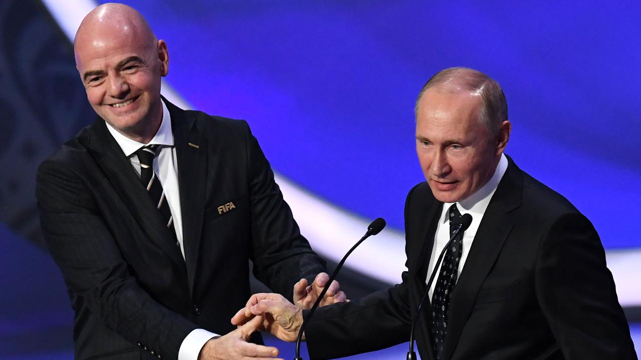 FIFA president Gianni Infantino smiles with Russian President Vladimir Putin at the 2018 FIFA World Cup football tournament final draw.