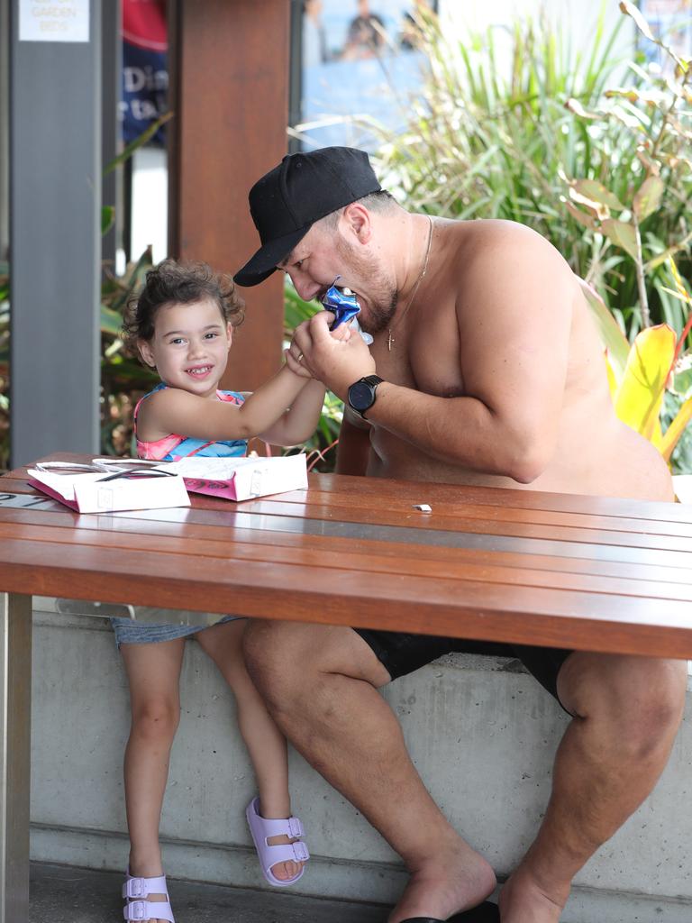 Faces of the Gold Coast, at Broadbeach. Lara Tipu 3 shares ice cream with dad Leroy Tipu of Bathurst... Picture Glenn Hampson