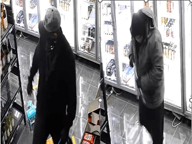 CCTV captured these two hooded men entering a Glen Waverley bottle shop before assaulting a worker. Picture: Victoria Police