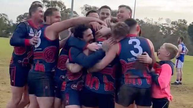 Eastern Park players mob Shawn Mansell in celebration after his 100th goal of the season. Picture: Supplied