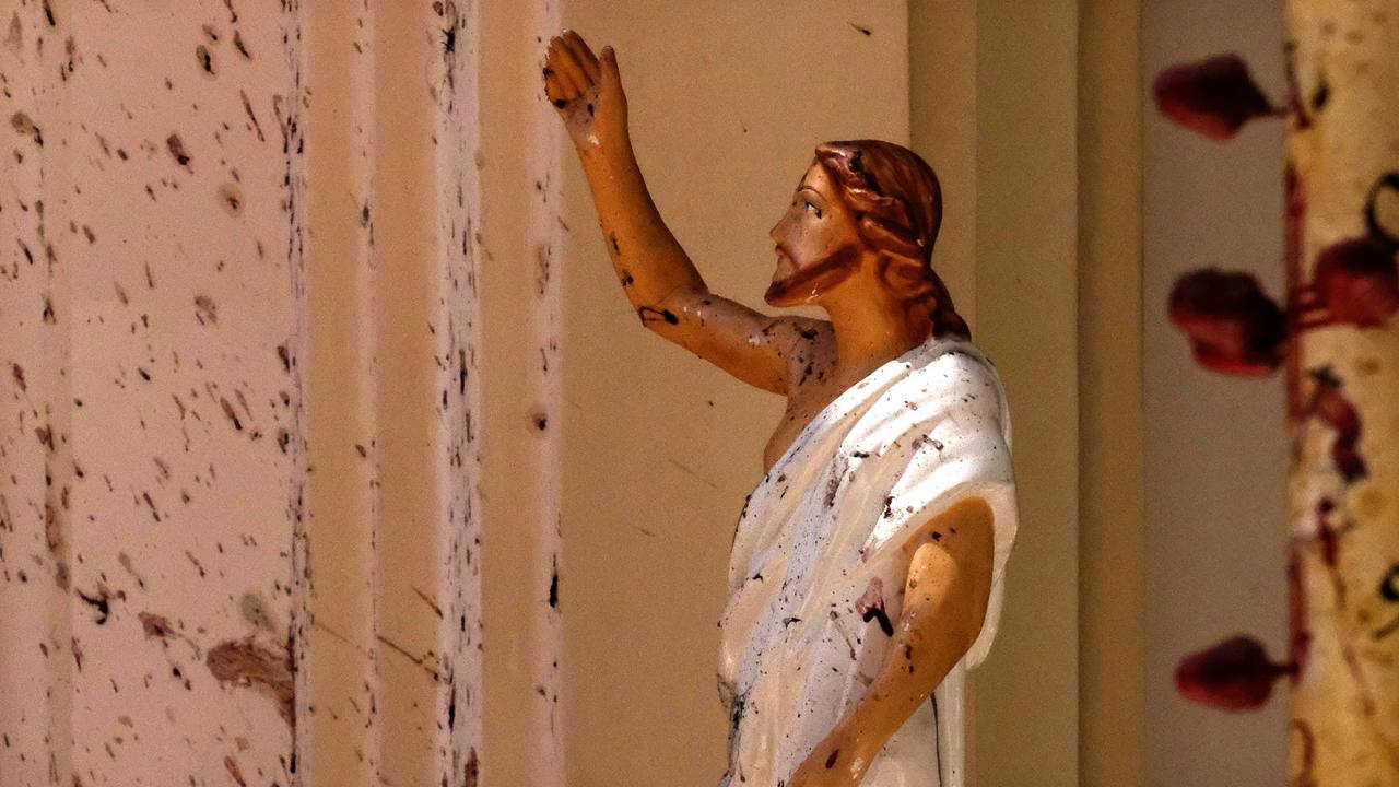 Blood stains are seen on the wall and on a Jesus Christ statue at the St. Sebastian's Church after the blast in Negombo, north of Colombo, Sri Lanka on Sunday. Picture: AP Photo.