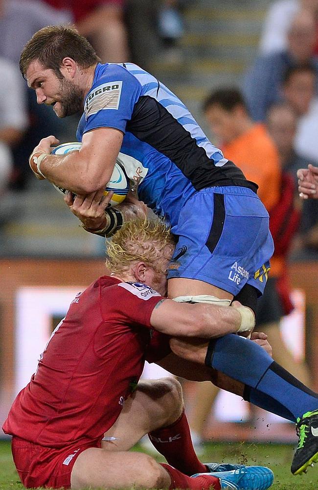 Ben McCalman tries to break through Beau Robinson’s tackle at Suncorp Stadium.