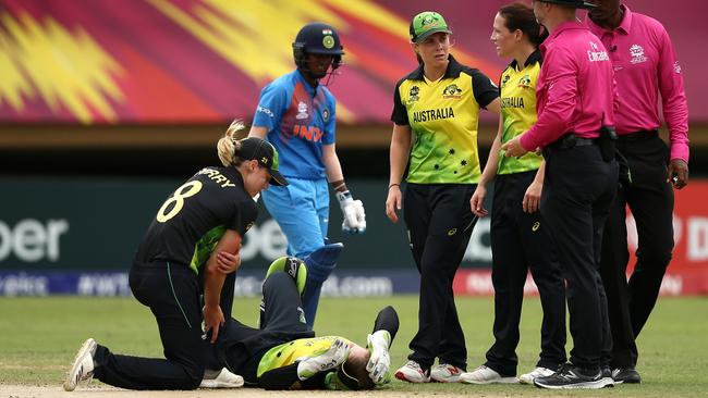 Players and umpires check on Alyssa Healy after her head knock. Picture: Getty Images