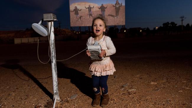 Elsie, 3, at the Coober Pedy drive-in theatre in Outback South Australia. Picture: Bernard Humphreys