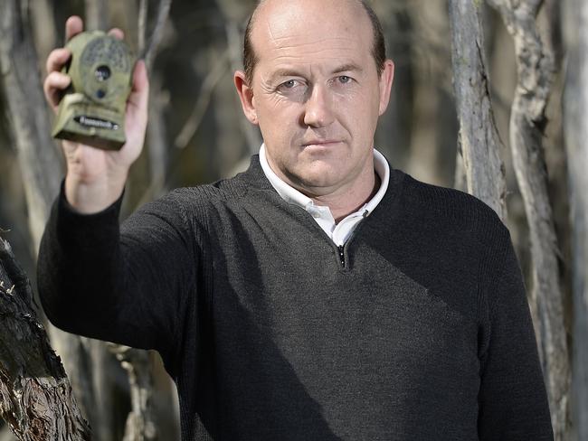 Michael Moss has been on the hunt for the Tasmanian tiger for almost two decades. He is pictured with one of the infra-red cameras he sets up on animal tracks. Picture: Jason Edwards