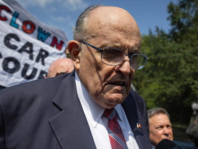 Rudy Giuliani faces the media after being booked outside the Fulton County Jail in Atlanta. Picture: AFP