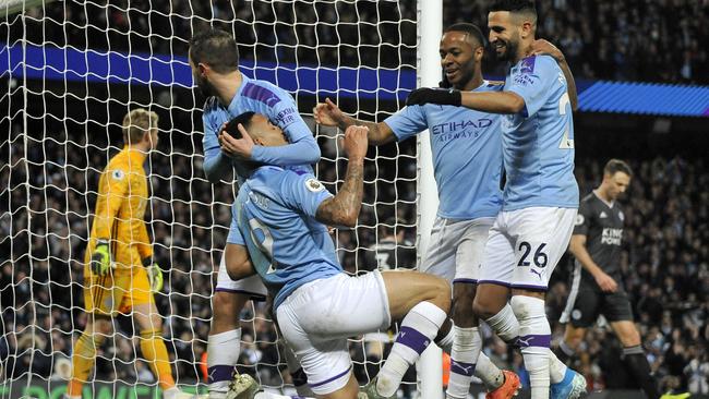 Manchester City's Gabriel Jesus, kneeling, scores against Leicester City