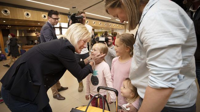 Karen Stephens meets her grandchildren Eloise Burgess 6, Freya Burgess 8 and Adelaide Burgess 3 after arriving on the first Qantas flight from Sydney to Hobart after the borders reopened. Picture Chris Kidd