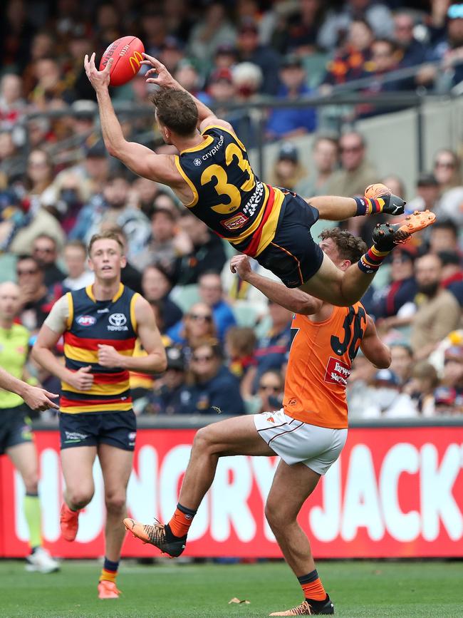 Brodie Smith flies over Giant Harry Perryman to mark. Picture: Sarah Reed/AFL Photos