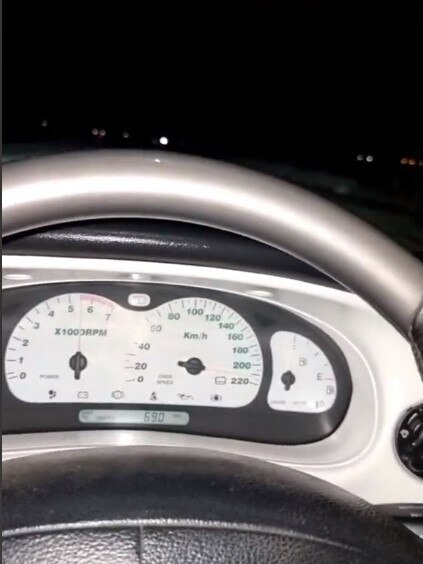 A TikTok user films himself while his speedo reads almost 220km/h. He is travelling alongside another person. Picture: TikTok