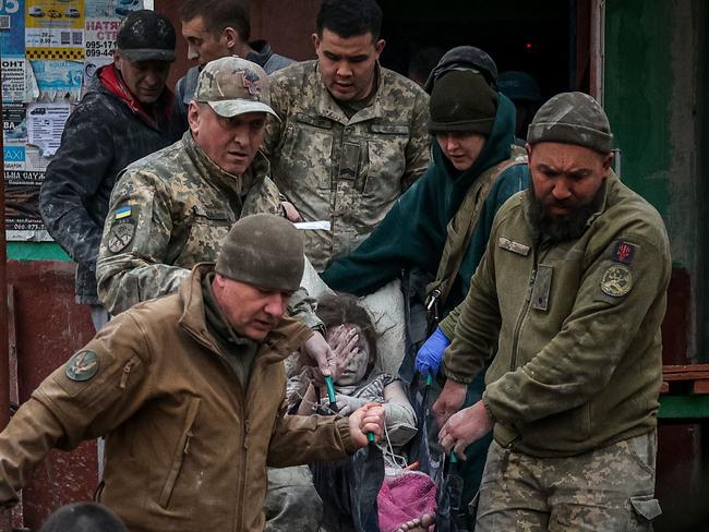 A young girl is rescued from a building that was struck when Russian forces shelled the eastern Ukraine city of Sloviansk on Saturday. Picture: AFP