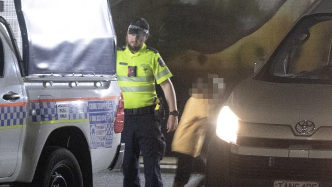 A young Indigenous Australian is released from a police cage truck and enters a local youth organisation vehicle to be returned to a town camp near Alice Springs. Picture: Liam Mendes