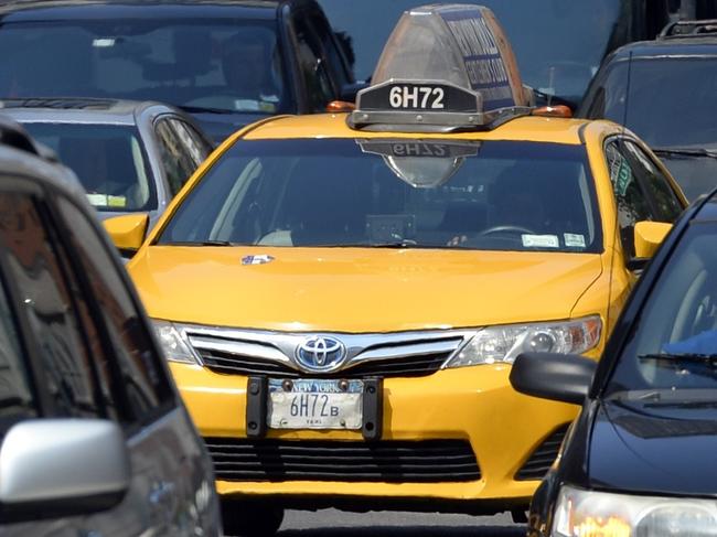 A New York City Taxi comes down 2nd Avenue in New York on July 10, 2014. The battle between ride-sharing and traditional taxi service is heating up in New York, with a new rival for ride-seekers declared illegal even before launching. Lyft, a ride-sharing service that operates in 60 US cities and competes with the likes of Uber, announced plans to launch Friday in the city boroughs of Brooklyn and Queens, claiming these communities are 