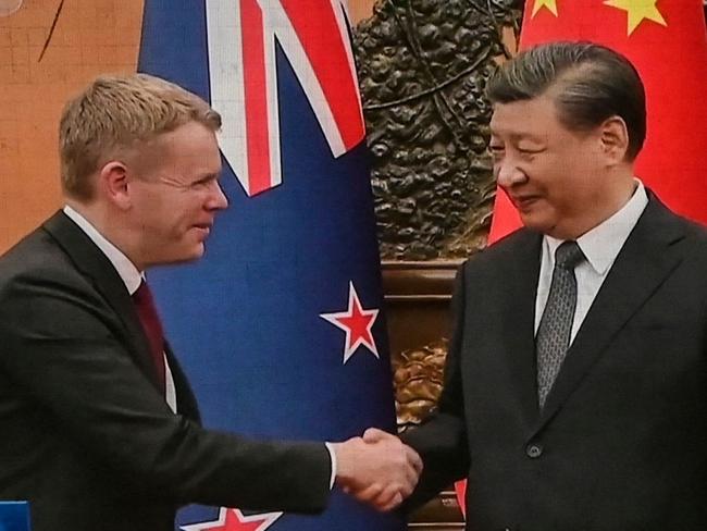 An outdoor screen shows news coverage of New Zealand's Prime Minister Chris Hipkins meeting with China's President Xi Jinping at the Great Hall of the People, along a street in Beijing on June 27, 2023. (Photo by Jade Gao / AFP)