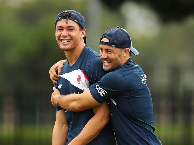 SYDNEY, NEW SOUTH WALES - MARCH 05:  Joseph Manu and Cooper Cronk share a laugh during a Sydney Roosters NRL training session at Kippax Lake on March 5, 2018 in Sydney, Australia.  (Photo by Mark Kolbe/Getty Images)