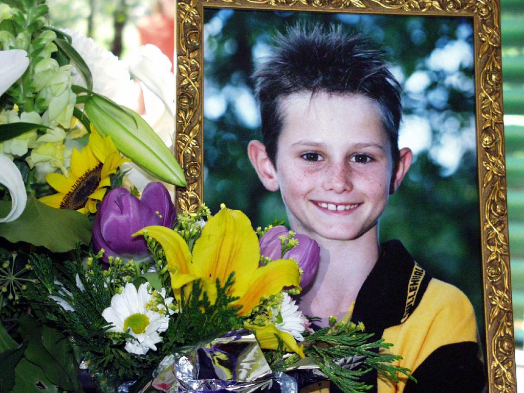 Photograph of Clinton Gage and floral tribute at his memorial service.