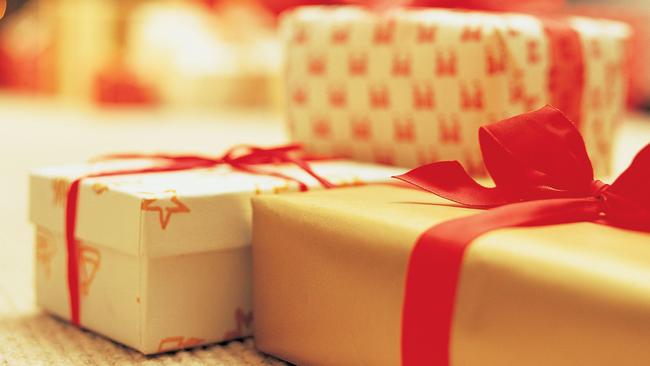 Close-Up of Presents with Christmas Tree in Background